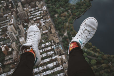 Low section of person wearing canvas shoes