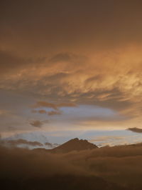 Scenic view of mountains against dramatic sky