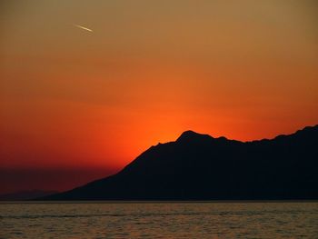 Scenic view of calm sea at sunset