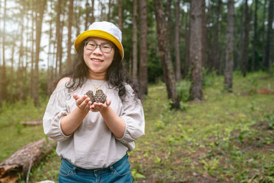 Portrait of a smiling young woman in forest