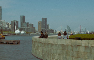 Group of people in city against buildings