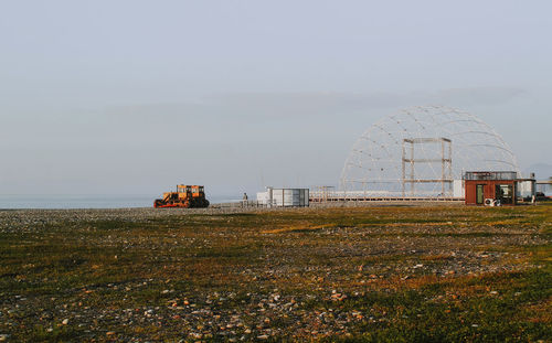 Traditional windmill on field against sky