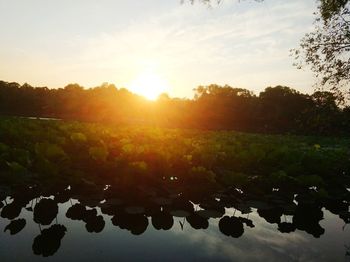 Scenic view of lake against sky during sunset