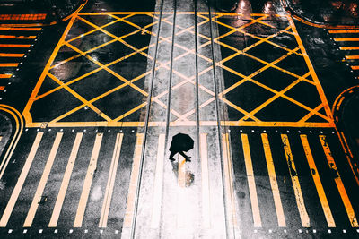 High angle view of man walking on road