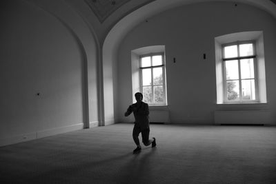 Rear view of woman walking in tunnel