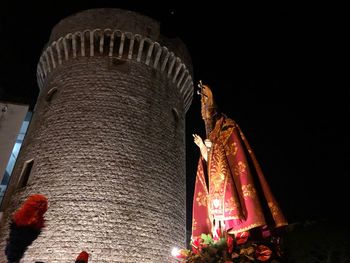 Low angle view of illuminated building against sky at night