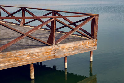 Part of the wooden fence of the pier on the lake on an autumn morning