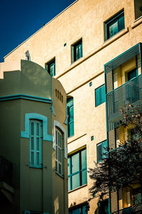 Low angle view of buildings against blue sky