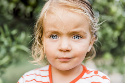 Close-up portrait of cute girl standing outdoors