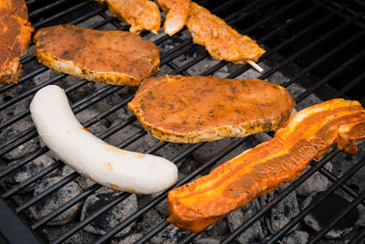 High angle view of meat on barbecue grill