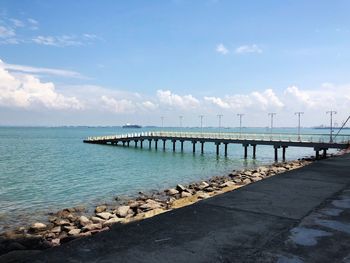 Pier over sea against sky