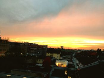 High angle view of townscape against orange sky