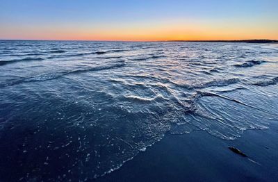 Scenic view of sea against clear sky during sunset