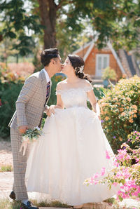 Rear view of bride holding bouquet