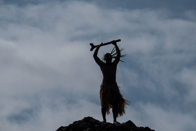 Low angle view of horse on rock against sky