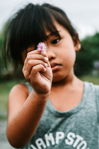 Close-up of girl holding flower