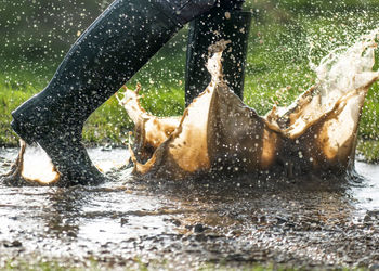 Low section of person running in water