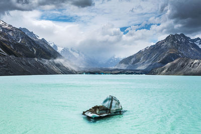 Scenic view of sea and mountains against sky