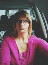 Portrait of young woman in car