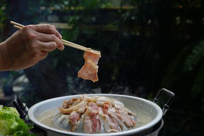 Thailand style bbq grill on a charcoal fire that is located on the bottom with pork, shrimp, squid 
