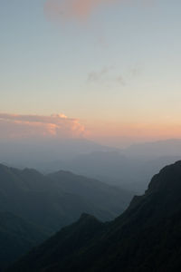 Scenic view of silhouette mountains against sky during sunset