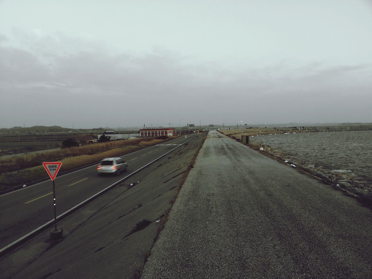 the way forward, transportation, sky, diminishing perspective, vanishing point, road, road marking, cloud - sky, landscape, cloudy, empty, tranquil scene, tranquility, long, asphalt, cloud, nature, horizon over land, overcast, day