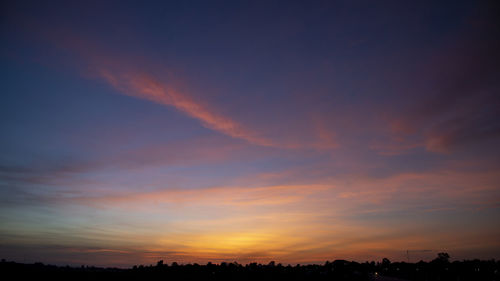 Low angle view of silhouette trees against sky during sunset