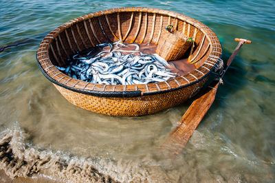 High angle view of basket with fish in lake