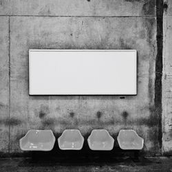 Empty chairs against wall