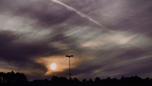 Low angle view of silhouette trees against sky at sunset