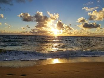 Scenic view of beach against sky during sunset