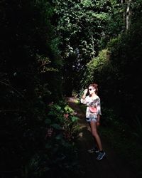 Full length of woman standing on tree