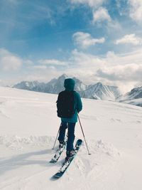 Rear view of man skiing on snowcapped mountain