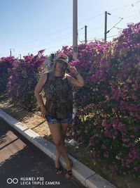 Full length of woman with pink flowers