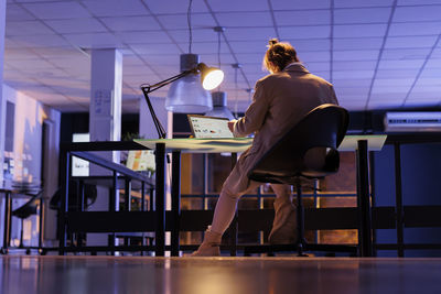 Side view of woman exercising in gym