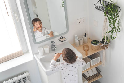 Portrait of woman standing in bathroom