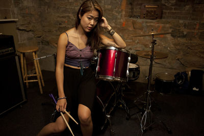 Young woman standing by her drum kit