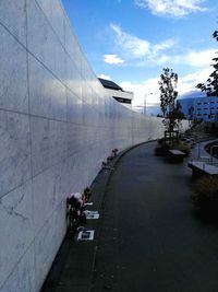 People on footpath against sky