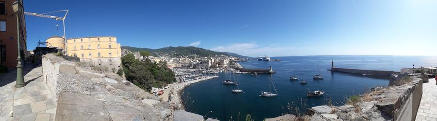 Panoramic view of sea and buildings against sky