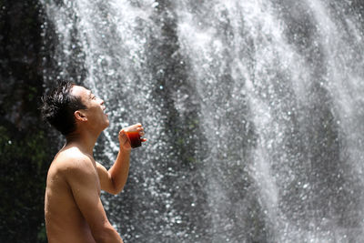 Drinking coffee near the waterfall is fun