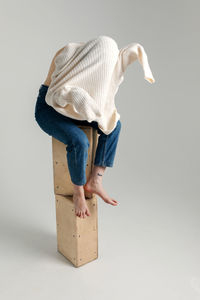 Midsection of woman wearing hat against white background