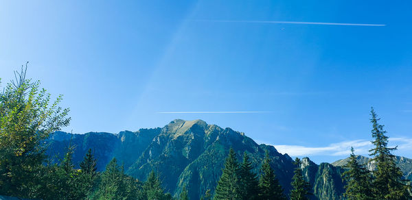 Scenic view of mountain against blue sky