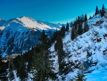 Scenic view of snowcapped mountains against clear blue sky