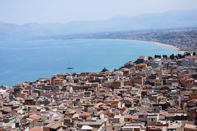 View of town by sea against clear sky