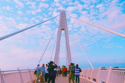 People enjoying against cloudy sky