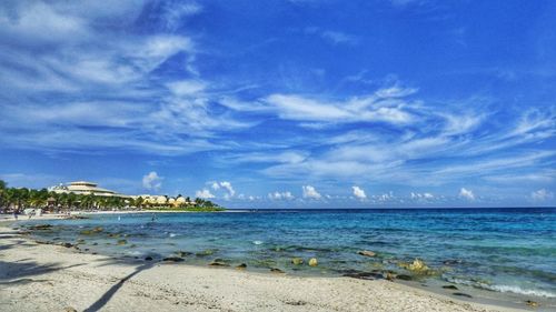 Scenic view of beach against blue sky