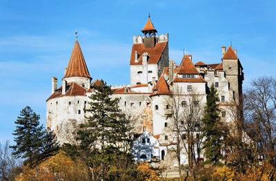 Low angle view of bran castle against sky