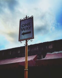 Low angle view of signboard against sky