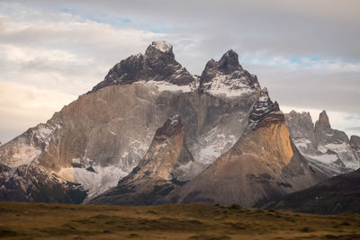 Scenic view of mountains against cloudy sky