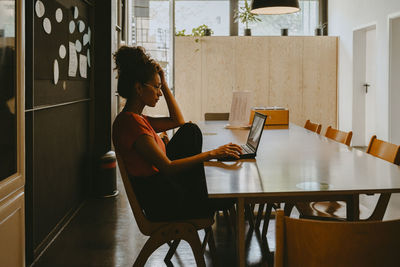 Female entrepreneur working on laptop in office